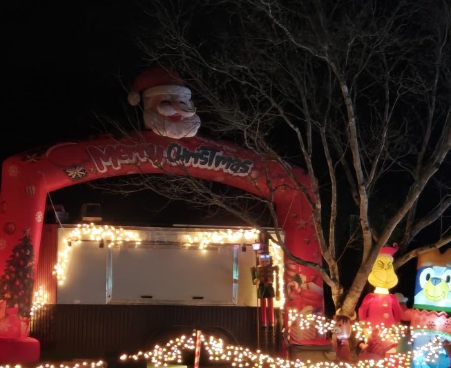 The Merry Christmas arch at GreenWood Lights, where the vending trailer sets up in season.